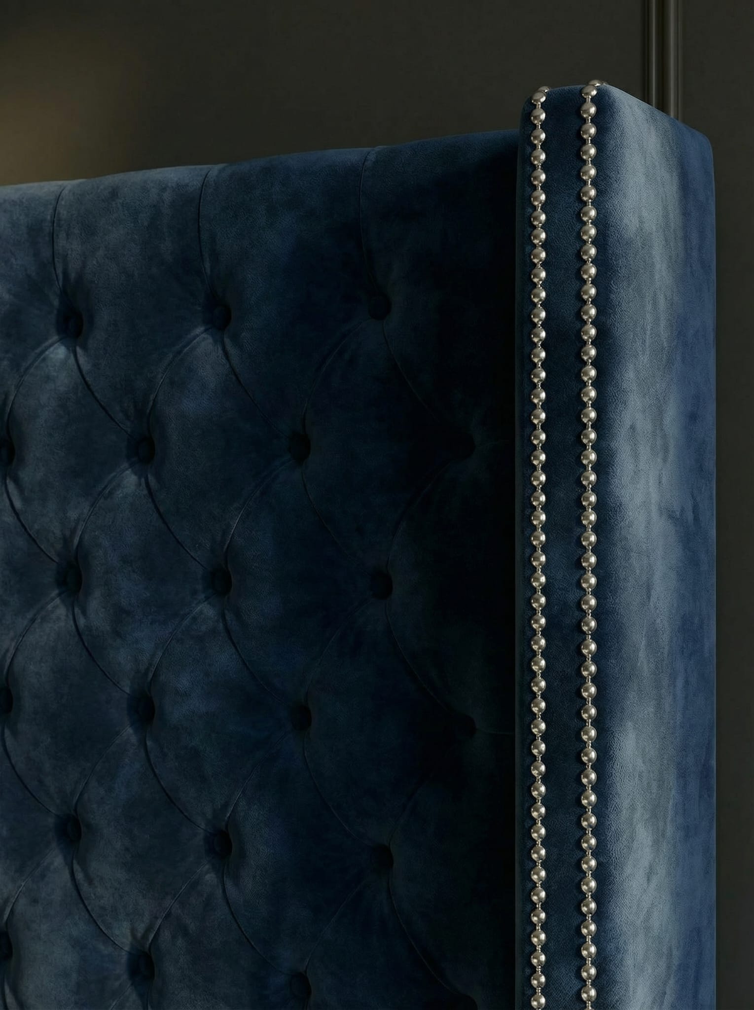 Close-up of an upholstered wingback bed for a fabric-safe bed care guide
