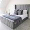 plush grey bed with winged headboard